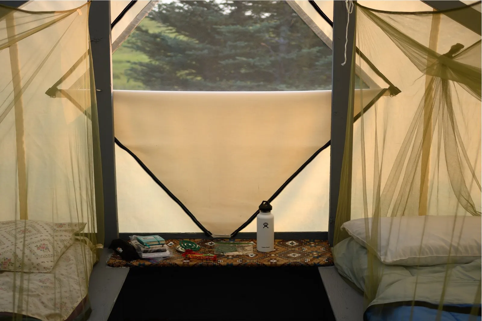 Inside camp tent with comfortable bedding